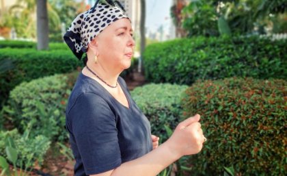 Image, Adobe. Woman wearing head scarf power walking through park. Adobe